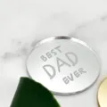 Detailed close-up of a silver mirror acrylic Best Dad Ever cake topper on white marble. - Round-BEST DAD EVER Style / 5cm Diameter / 1.3mm Thickness / Silver