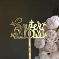 Close-up detail of gold mirror acrylic Super Mom cake topper with lovely pink flowers. - Super Mom / Width Approx. 7-9cm / Gold