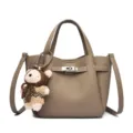 Women leather handbag bucket tote bag with cute bear pendant and metal lock closure stylish. - Gray