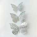 Close-up of silver hollow butterfly cake toppers for birthday party and mother's day. - Style 2 / Set of 12 / Silver