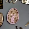 Easter acrylic rabbit hanging ornament detail shot showing cute bunny and engraved wooden design. - Double-Layer Rose Gold Egg Pendant + Wooden Engraved