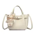 Elegant cream leather handbag with turn-lock closure and cute knitted bear pendant for women. - Off White