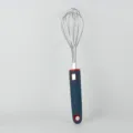 Close-up detail shot of stainless steel wire whisk with blue and red silicone handle for baking. - Whisk