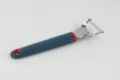 Stainless steel kitchen vegetable peeler detail with ergonomic silicone handle for cooking. - Julienne Graters