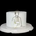 Vista detallada del adorno para tarta de graduación de acrílico dorado, diseño minimalista. - Doctor Sosteniendo Libro / Dorado