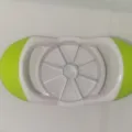 Multifunctional stainless steel apple slicer and fruit cutter with comfortable plastic handles. - Green and White