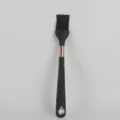 Black silicone basting brush with rose gold accent, durable kitchen baking tool detail view. - Oil Brush
