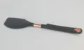 Detailed view of black silicone spatula with rose gold accents, heat resistant baking tool. - Spatula