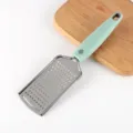 Stainless steel kitchen cheese grater with ergonomic green handle for home cooking use. - Small Hole Ginger Graters