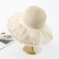 Close-up detail of the elegant organza bow and pearl embellishment on the straw sun hat. - M (56-58cm) / Pearl Full Crown Style - Beige