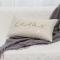 Beige lumbar pillow with gold foil relax text and grey knit blanket detail close up view. - 30*50cm (Insert Not Included) / Beige Linen "Relax" Gold Foil