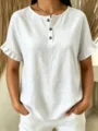 Close-up detail of white linen short sleeve blouse with ruffle cuff and brown buttons. - S / Tops / White