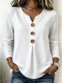 Detailed view of women casual white V-neck long sleeve top with large wooden buttons. - S / Tops / White