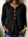 Close-up detail of women's long sleeve V-neck top featuring large decorative wooden buttons. - S / Tops / Black