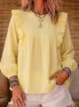 Detailed close-up view of the yellow bohemian ruffle blouse showing elegant long sleeves. - S / Yellow