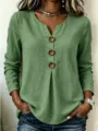 Detail view of the casual green V-neck long sleeve top featuring large wooden buttons. - S / Tops / Green