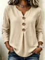 Detail shot of the khaki linen V-neck long sleeve blouse featuring large wooden buttons. - Khaki
