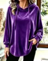 Close-up detail of the soft purple velvet hoodie featuring a cozy drawstring and long sleeves. - Purple
