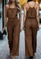 Brown textured halter jumpsuit with cinched drawstring waist and elegant draped wide-leg fit. - S / Dark Brown