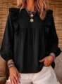 Detailed view of women's black long sleeve ruffle blouse with bubble sleeves and chic design. - S / Black