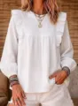 Close-up detail of women's white bohemian ruffle long sleeve blouse, textured fabric. - S / White