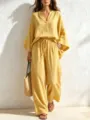 Detail view of the elegant yellow linen two-piece set featuring relaxed V-neck and comfy pants. - S / Top And Bottom / Yellow