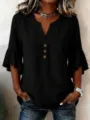 Detailed view of the black V-neck ruffle sleeve casual shirt with wooden buttons. - S / Tops / Black