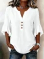 Detail view of the white linen V-neck blouse with chic ruffle sleeves and button front. - S / Tops / White