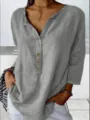 Close-up view of the casual grey long-sleeve shirt featuring a stylish notch neck and wooden buttons. - S / Gray