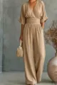 Detailed close-up view of the elegant khaki V-neck jumpsuit with a chic waist design. - Khaki