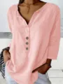 Close-up detail of the women pink notch neck casual button up long sleeve blouse top. - Pink