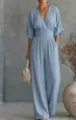 Detail view of the casual light blue V-neck women's jumpsuit with cuffed sleeves and waist. - S / Sky Blue