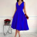 Detailed view of the elegant royal blue sleeveless V-neck midi dress in a chic room setting. - S / Blue