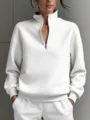 Detail view of a women's solid white half-zip long sleeve sweatshirt casual fashion top. - S / Tops / White