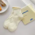 Calcetines de tubo medio de algodón liso para mujer, estilo casual simple, suaves y transpirables. - Talla única / Amarillo Leche