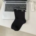 Black preppy style crew socks with white stripes and number 05 knit design for women. - Black