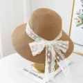 Women's summer straw sun hat with white lace bow ribbon wide brim beach hat elegant design - M (56-58cm) / JS32010 Coffee