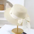 Women summer flat top straw sun hat with elegant white bow ribbon beach vacation hat. - M (56-58cm) / JS80461-15 Beige