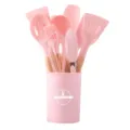 Pink silicone kitchen utensils set with wooden handles and storage bucket for cooking. - Pink
