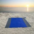 Outdoor waterproof beach blanket detail view, portable folding picnic mat set on sand. - Royal Blue Body with Double Gray