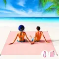 Detail view of portable waterproof pink beach blanket with storage bag and carabiner for outdoor. - Pink