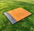 Waterproof outdoor camping picnic blanket pocket beach mat detail view showing durable fabric - Main Orange + Gray