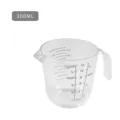 Clear plastic measuring cup with handle and scale markings for kitchen baking and cooking use. - 300ML