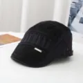 Detail view of a black vintage flat cap showing the front metal label and fine fabric stitching. - Adult Style (Head Circumference 55-58cm) Adjustable / Black (Retro Vertical Stripe Flat Cap)
