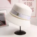 Elegant white straw bucket hat detail featuring pearl fringe, silver glitter trim and M logo. - M(56-58CM) Adjustable / White