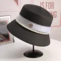 Elegant black straw bucket hat for women with pearl chain ribbon and rhinestone M logo design. - M(56-58CM) Adjustable / Black