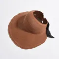 Brown straw sun visor hat for women, empty top summer beach hat with stylish black bow. - Caramel color
