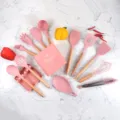 Pink silicone kitchen utensil set with wooden handles, 14-piece cooking tools with storage bucket. - 14 Piece Set / Pink