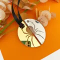 Close-up detail of Halloween acrylic mirror spider hanging ornament with black ribbon. - Laser Engraved Round Spider (Diameter 5cm)