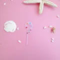 Pink acrylic number 9 cake topper detail, ocean theme birthday party decoration close-up view. - 9 / S